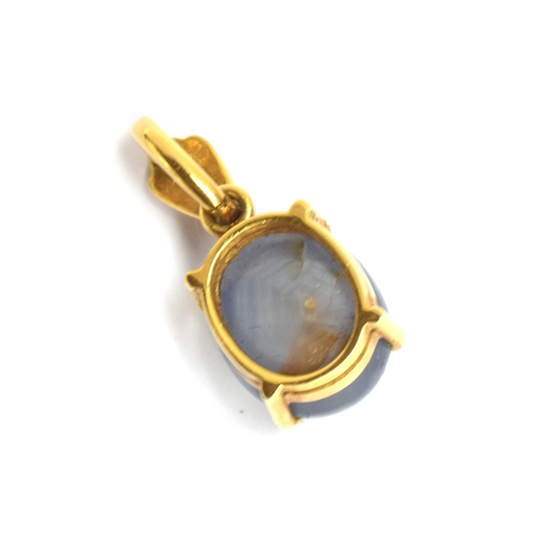 73 - An 18ct gold mounted star sapphire cabochon pendant, approx. 12cts, the bail set with a small diamon... 