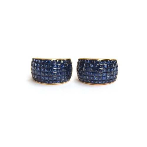 57 - A pair of heavy 18ct gold earrings set with calibre cut sapphires, each set with approx. 4.7cts of s... 
