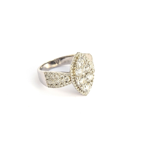 76 - A substantial 18ct white gold diamond ring of navette form, the six central large diamonds set overl... 