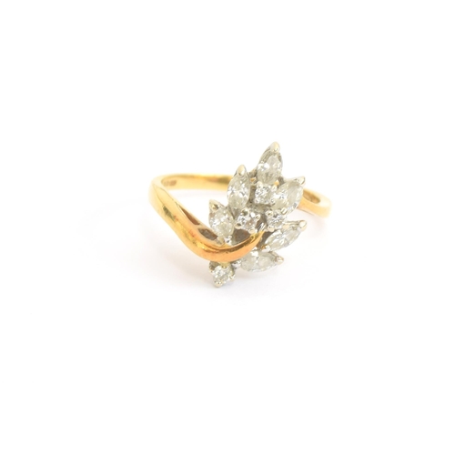 78 - An 18ct gold ring set with a leaf shaped spray of marquise and brilliant cut diamonds, size N, 4.1g