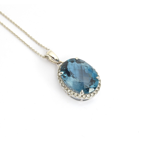 89 - A 14ct white gold blue topaz and diamond pendant, the checkerboard cut topaz approx. 9cts, on a 14ct... 