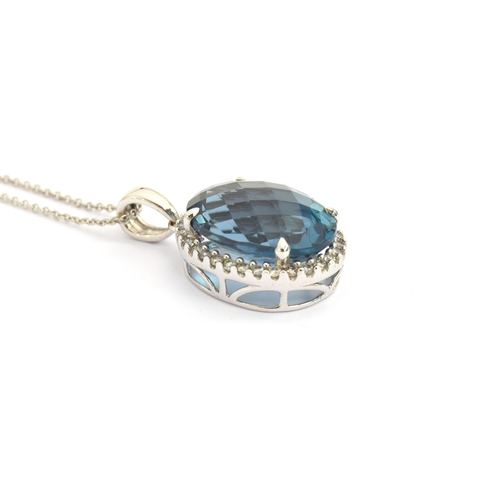 89 - A 14ct white gold blue topaz and diamond pendant, the checkerboard cut topaz approx. 9cts, on a 14ct... 