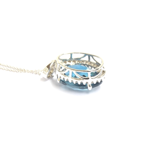 89 - A 14ct white gold blue topaz and diamond pendant, the checkerboard cut topaz approx. 9cts, on a 14ct... 