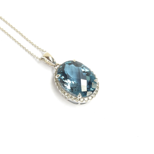 89 - A 14ct white gold blue topaz and diamond pendant, the checkerboard cut topaz approx. 9cts, on a 14ct... 