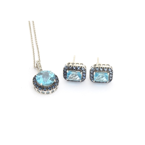 87 - A 14ct white gold pendant set with a central checkerboard cut blue topaz surrounded by sapphires, wi... 