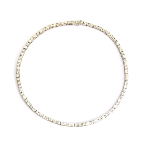 50 - An impressive 18ct white gold riviere necklace set with alternating brilliant cut and baguette cut d... 