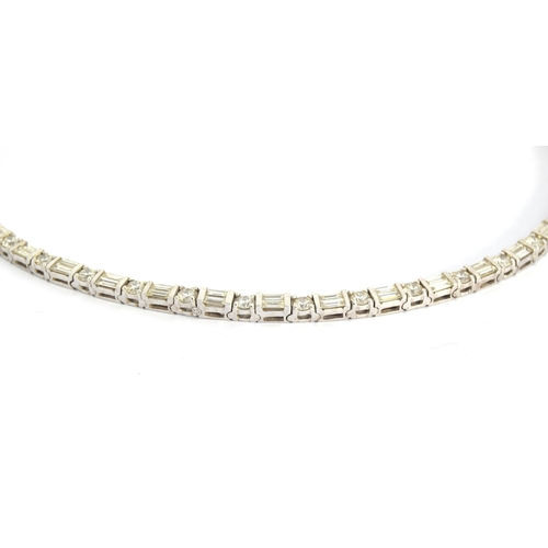 50 - An impressive 18ct white gold riviere necklace set with alternating brilliant cut and baguette cut d... 