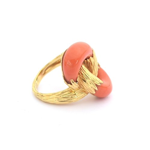 93 - A 1970s heavy 18ct gold and coral Kutchinsky ring of interlocking design, the carved coral set into ... 