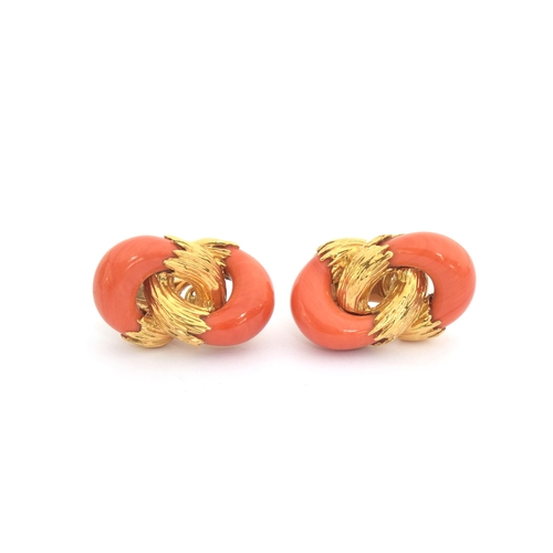 94 - A 1970s pair of heavy 18ct gold and coral Kutchinsky earrings of interlocking design, the carved cor... 