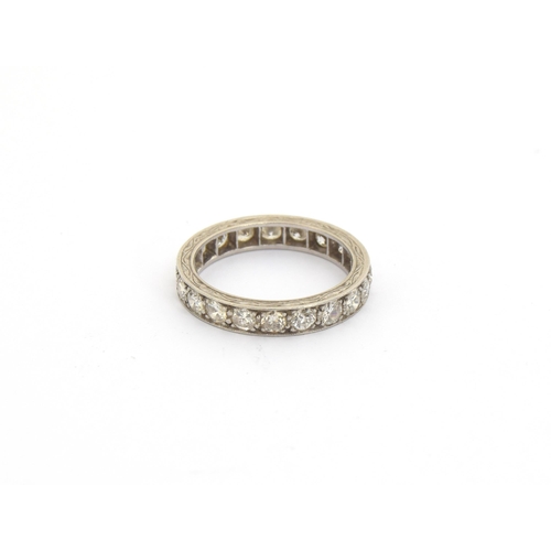 48 - An Art Deco platinum and diamond full eternity ring, hand engraved scrolling decoration to edges, th... 