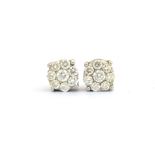 81 - A pair of white gold earrings each set with a cluster of eight brilliant cut diamonds, 0.7cm diamete... 