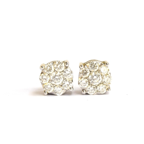 81 - A pair of white gold earrings each set with a cluster of eight brilliant cut diamonds, 0.7cm diamete... 