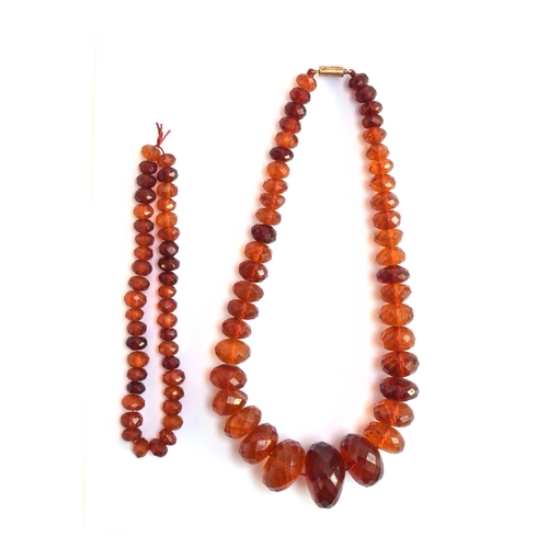 26 - A faceted amber bead necklace, the beads graduating from 1.2cm to 3.5cm diameter, fastening with a y... 