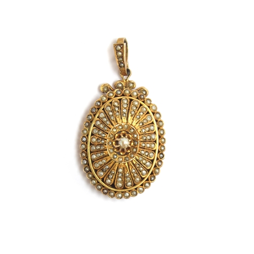 35 - A Victorian yellow metal locket, profusely set with seed pearls in rayed petal shaped settings, cent... 