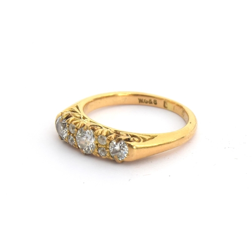 6 - An 18ct gold and diamond ring, three larger diamonds interspersed with four small diamonds, hallmark... 