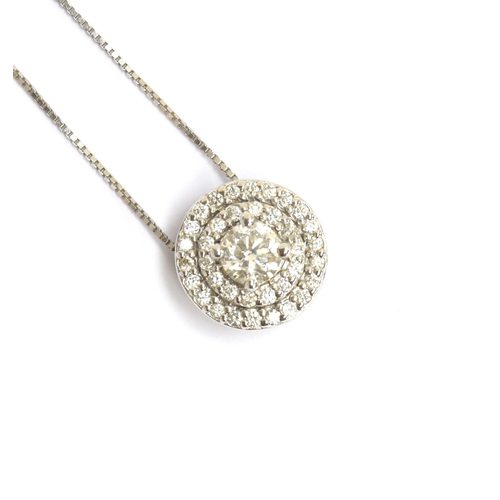 82 - A 14ct white gold and diamond cluster circular pendant on chain, the central diamond approx. 0.25cts... 