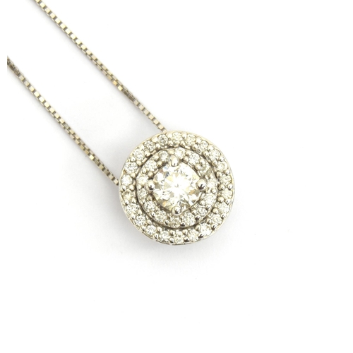 82 - A 14ct white gold and diamond cluster circular pendant on chain, the central diamond approx. 0.25cts... 