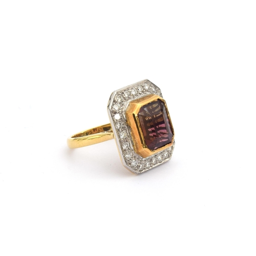 84 - An 18ct gold cluster ring set with an emerald cut bicolour pink tourmaline, approx. 8cts, surrounded... 