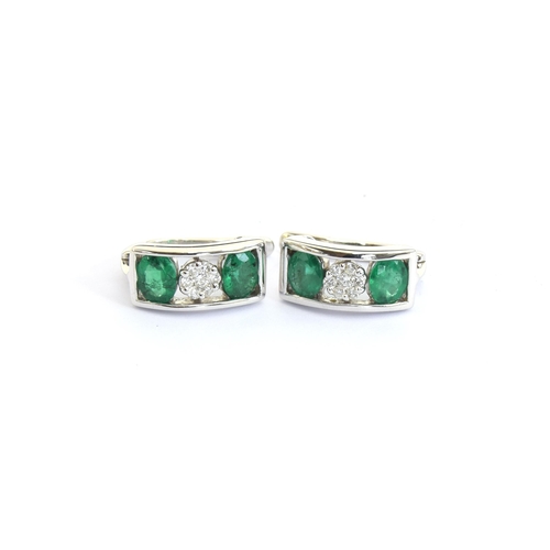 53 - A pair of 14ct white gold, emerald and diamond earrings, total carat weight of the four emeralds app... 