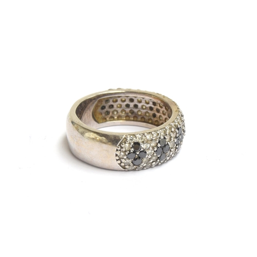 61 - A white metal band set with black and white diamonds, unhallmarked but tests as 14ct gold, total car... 