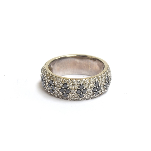 61 - A white metal band set with black and white diamonds, unhallmarked but tests as 14ct gold, total car... 