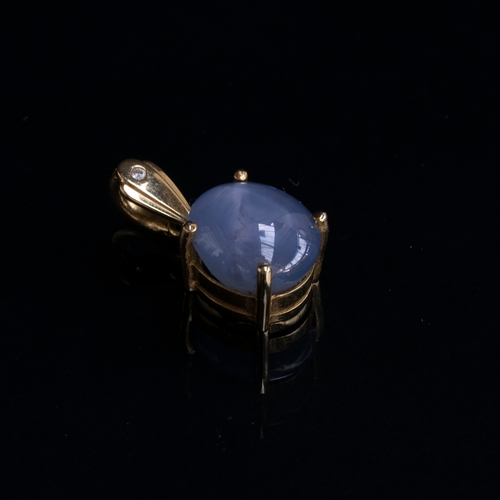 73 - An 18ct gold mounted star sapphire cabochon pendant, approx. 12cts, the bail set with a small diamon... 