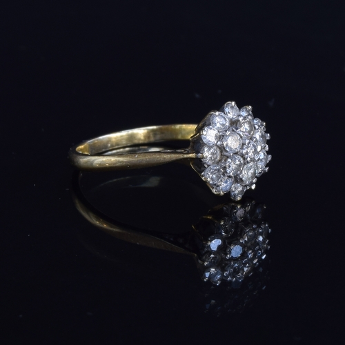 77 - An 18ct gold diamond cluster ring, the diamonds totalling approx. 1ct, size P 1/2, 4.3g