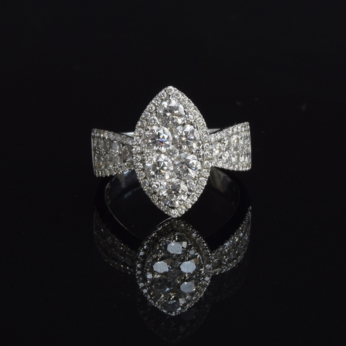 76 - A substantial 18ct white gold diamond ring of navette form, the six central large diamonds set overl... 