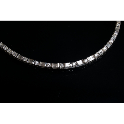 50 - An impressive 18ct white gold riviere necklace set with alternating brilliant cut and baguette cut d... 