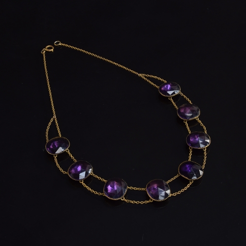 21 - An 18th century 'Queen Anne' amethyst paste riviere necklace, the eight rose cut paste stones each a... 