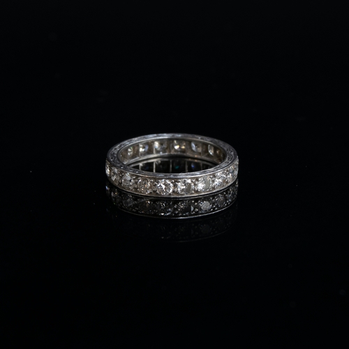 48 - An Art Deco platinum and diamond full eternity ring, hand engraved scrolling decoration to edges, th... 