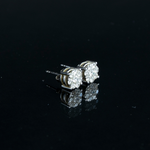 81 - A pair of white gold earrings each set with a cluster of eight brilliant cut diamonds, 0.7cm diamete... 