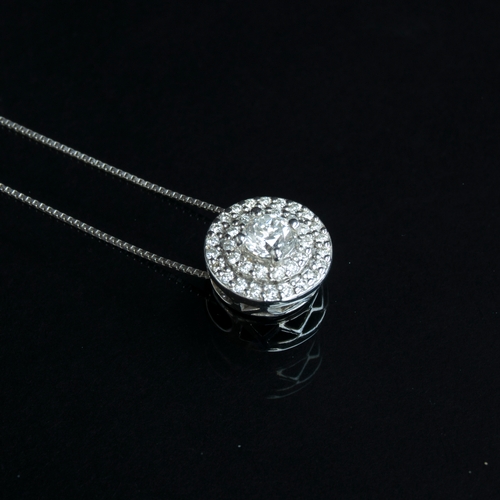 82 - A 14ct white gold and diamond cluster circular pendant on chain, the central diamond approx. 0.25cts... 