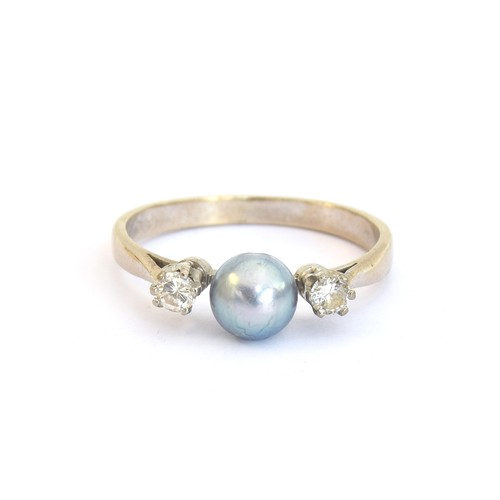 92 - An 18ct white gold ring set with a central pearl and two diamonds, size N 1/2, 2.4g