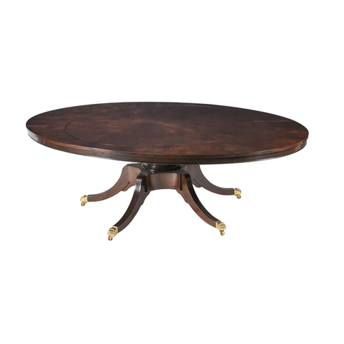 492 - A mahogany concentric extending dining table in Regency style, with four additional elliptical leaf ... 