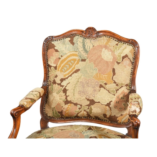 513 - A pair of beechwood fauteuil armchairs in Louis XV design, early 20th century, with needlework uphol... 