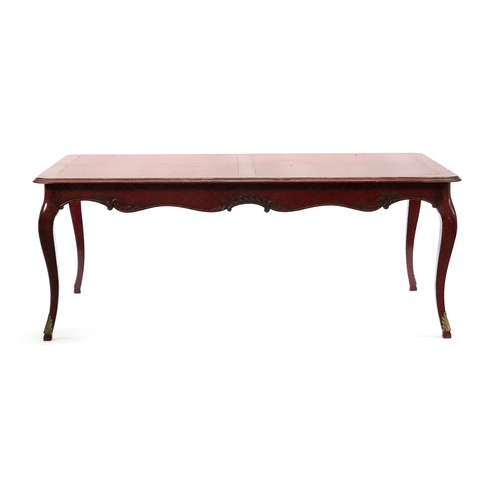 550 - A red painted extendable dining table by Moissonnier, having a shaped carved apron on faceted cabrio... 