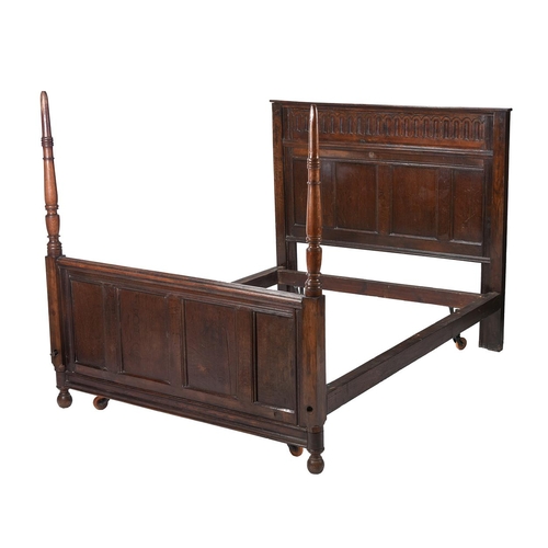 518 - An oak panelled bed, incorporating some old elements, the panelled bedhead 142cm high, the turned en... 