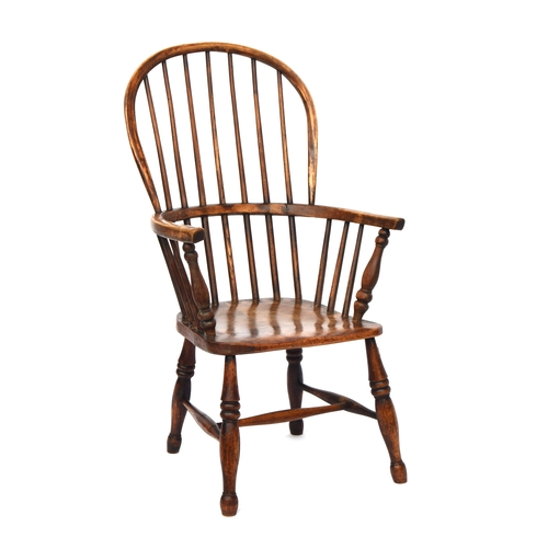 503 - A 19th century Windsor chair, ash and elm, stick back, turned underarm supports, on ring turned legs... 