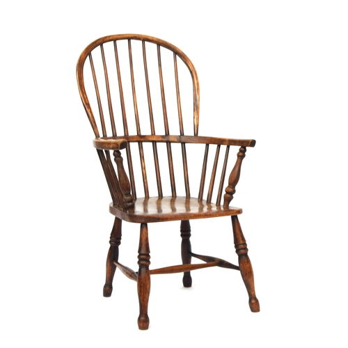 503 - A 19th century Windsor chair, ash and elm, stick back, turned underarm supports, on ring turned legs... 