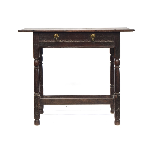 446 - A 17th century oak side table, plank top with cleated ends, single carved frieze drawer, on reel tur... 