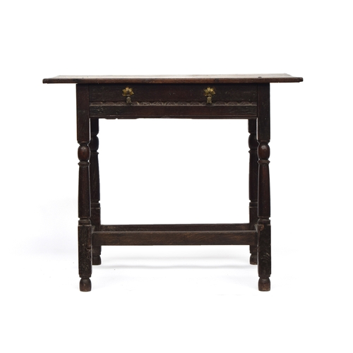 446 - A 17th century oak side table, plank top with cleated ends, single carved frieze drawer, on reel tur... 