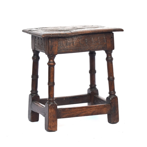 447 - A 17th century oak joint stool, the moulded seat raised on ring turned supports joined by peripheral... 