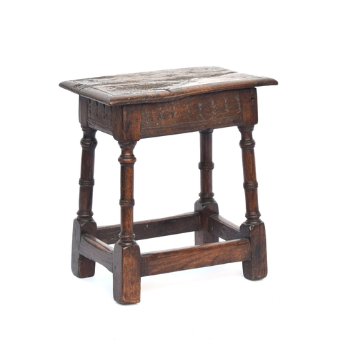 447 - A 17th century oak joint stool, the moulded seat raised on ring turned supports joined by peripheral... 