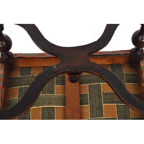 504 - A William and Mary style upholstered footstool, the block turned legs joined by a shaped X stretcher... 