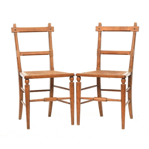 500 - A pair of light oak and caned side chairs in the manner of James Shoolbred, the octagonal faceted fr... 