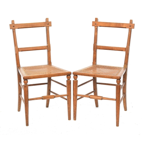 500 - A pair of light oak and caned side chairs in the manner of James Shoolbred, the octagonal faceted fr... 