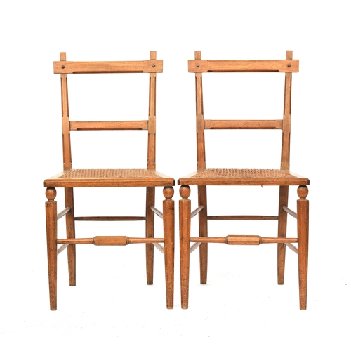 500 - A pair of light oak and caned side chairs in the manner of James Shoolbred, the octagonal faceted fr... 