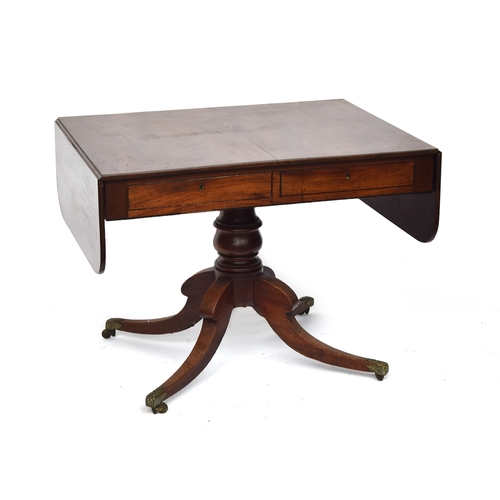 468 - A William IV mahogany sofa table, on a turned column and four swept legs with acanthus caps and bras... 