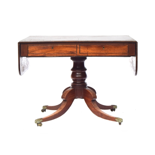 468 - A William IV mahogany sofa table, on a turned column and four swept legs with acanthus caps and bras... 